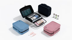 Travel toiletry bags in black, blue, and pink with organized toiletries and medicine bottles.